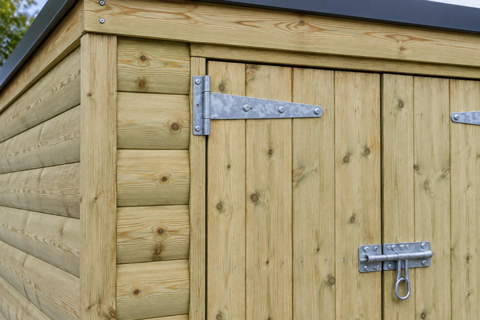 Pale green-treated log-lap cladding with galvanised hinge and pad bolt